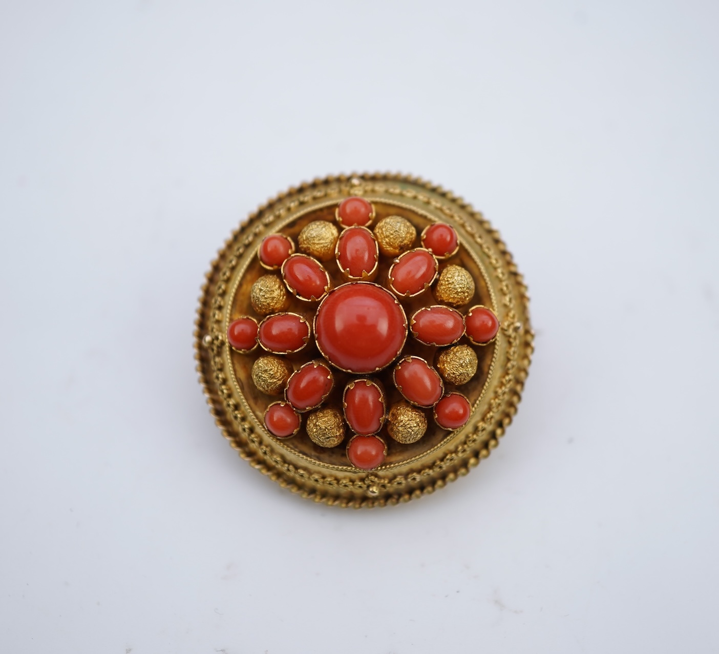 A Victorian gold and coral brooch, late 19th century